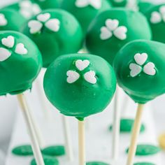 green cake pops with white hearts on them