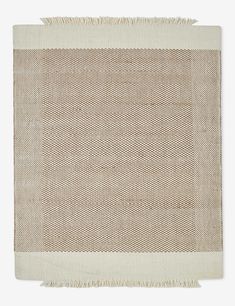 a beige and white rug with fringes on the bottom, in front of a white background