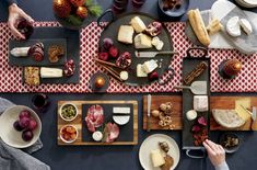 an overhead view of a table with cheeses and meats