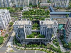 an aerial view of several buildings with trees growing on the roof and in the middle