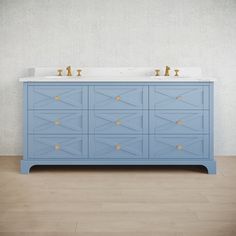 a bathroom vanity with two sinks and blue cabinet