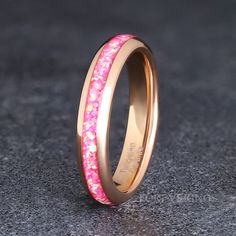 a pink and gold wedding ring with stars on it