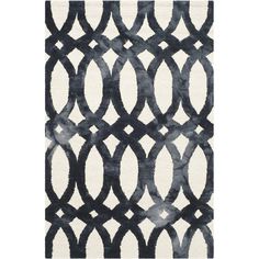 an area rug with black and white circles on the side, in front of a white background