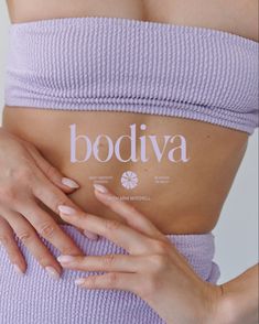 a woman's stomach with the word boodiva written on it and her hands