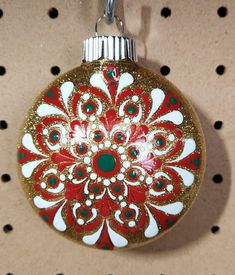 a red and white ornament hanging on a wall