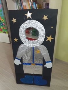 a cardboard box that has a paper bag on top of it with a man in space suit