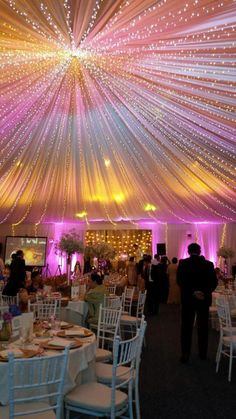 the inside of a tent with tables and chairs set up for an event or function