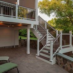 there is a patio with stairs leading up to the second floor