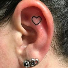 a person with a heart tattoo on their ear