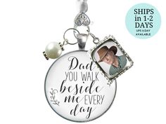 a keychain with a photo on it that says dad you walk beside me every day