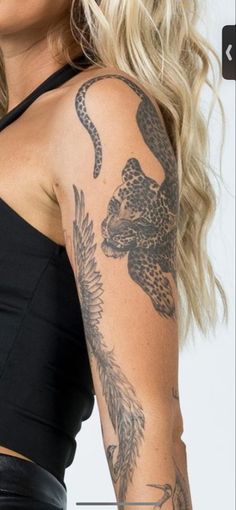 a woman with tattoos on her arm and shoulder