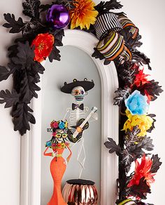 a decorated mantle with a skeleton and flowers on it