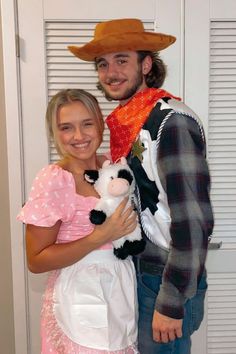 a man and woman dressed up in costumes posing for a photo with a cowgirl