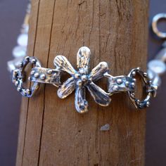 This is a simple bracelet of lovely white rice pearls and a sterling silver flower center. It is almost time to celebrate Summer and wearing this bracelet is the perfect way to do it! I make all my pieces in wax, then they are molded and cast for me. Finally I put them together in my Bernalillo shop. This bracelet is seven and a half inches long , but it could be sized to fit easily. All my pieces come packaged in a nifty little gift box, tied with a silver ribbon! Delicate Sterling Silver Pearl Bracelet In Silver, White Sterling Silver Bracelet, Handmade Delicate Pearl Bracelet With Flower Shape, Handmade Delicate Pearl Bracelet With Flower Design, Delicate Handmade Flower Pearl Bracelet, Handmade Sterling Silver Pearl Bracelet, Handmade Sterling Silver Pearl Bracelet In Silver, Handmade Sterling Silver Bracelet In White, Handmade White Sterling Silver Bracelet