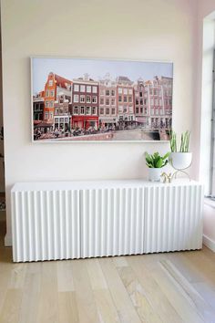 a white radiator sitting in front of a window