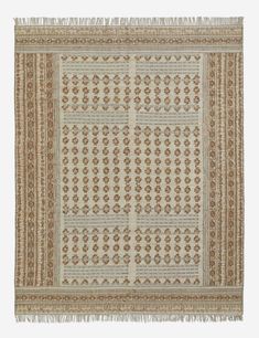 a beige and brown rug with an intricate design