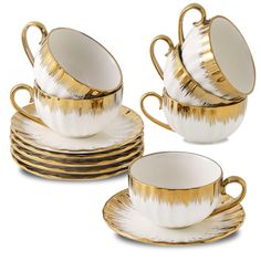 gold and white porcelain tea set with matching saucers