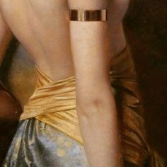 the back of a woman's dress, with her hand on her hip and wearing a gold bracelet