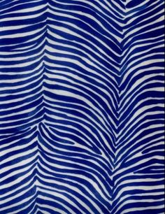 a blue and white striped fabric with wavy lines on the bottom, as if it were painted