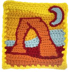 a crocheted square with an orange and red letter in the center, on a white background