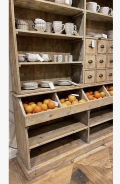 an old wooden shelf filled with lots of dishes and other things on it's shelves