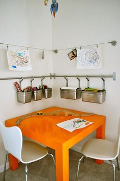 an orange table and chairs in a room