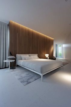 a large white bed sitting in a bedroom next to a tall wooden paneled wall