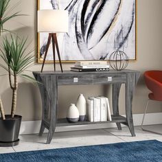 a living room scene with focus on the console table and chair next to the painting