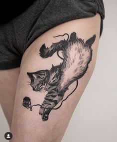 a woman with a cat tattoo on her thigh