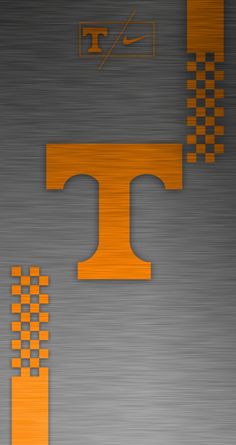 the letter t is made up of orange and black squares on a metal background with an arrow