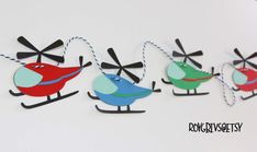 three colorful birds are hanging from string