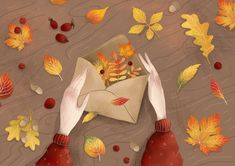 two hands reaching for an envelope with autumn leaves on it