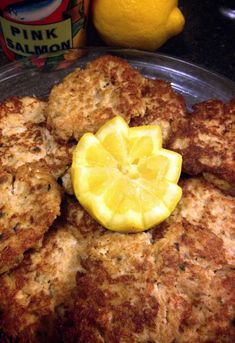 crab cakes with lemon wedges on a plate