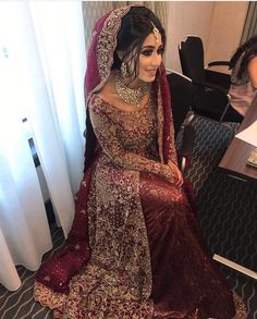 a woman in a red and gold bridal gown