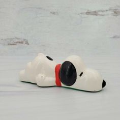 a toy dog laying down on the ground