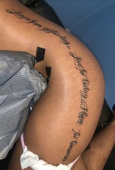 the back of a woman's thigh with writing on it