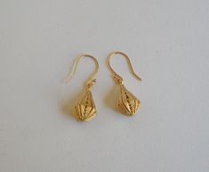 Lovely 24 x 12mm 24Kt gold plated brass filigree teardrops with a satin finish dangle from 17mm gold plated brass ball hook ear wires for an overall drop length of 1-1/2 inches. A travel pouch and gift box are included with every purchase. #1806 Gold Teardrop Pendant Earrings For Gift, Gold Drop Earrings For Gifts, Traditional Gold Earrings With French Hook, Gold Teardrop Drop Earrings, Gold Brass Long Drop Teardrop Earrings, Gold Teardrop Pierced Earrings, Gold Drop Earrings Gift Set, Gold Long Drop Teardrop Earrings As Gift, Pierced Gold Plated Teardrop Earrings