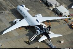 an airplane is parked on the tarmac at an airport