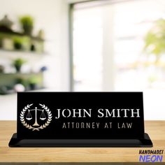 a wooden table with a business card holder on it that says, john smith at law