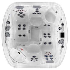 a hot tub that is in the middle of a white floor with several buttons on it