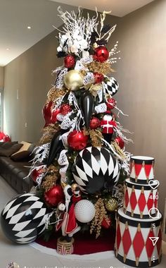 a christmas tree decorated with black, white and red ornaments