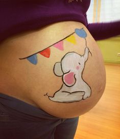 a pregnant belly with a drawing of a baby elephant on it's side and bunting