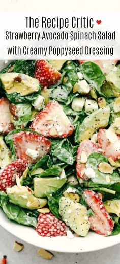 strawberry avocado spinach salad with creamy poppy seed dressing in a white bowl