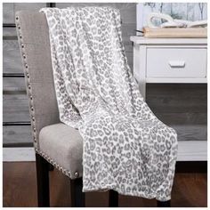 a chair with a leopard print blanket on it