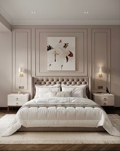 a large white bed sitting in a bedroom next to two nightstands and a painting on the wall