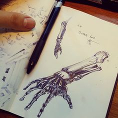 a drawing of a hand holding a knife on top of a piece of paper next to a pen