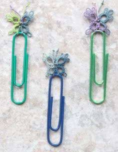 three different colored paper clips with flowers on them