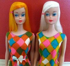 two dolls standing next to each other wearing colorful outfits and hair clips on their heads