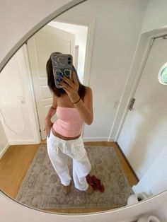 a woman taking a selfie in front of a mirror