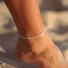 MELATI SHELL BEADED ANKLET Get your surf on with the Melati Shell Beaded Anklet! This beachy anklet features a beautiful white shell and is inspired by the national flower of Bali, known for its symbolism of purity. This unique piece of jewelry is perfect for surfers who want to bring a little bit of the ocean with them wherever they go! - Made with round shimmering troca shell beads, centred with a dainty seashell all strung on our durable wax polyester cord. - Measures approx. 20cm with a 10cm Anklets Shell, Seashell Anklet, Beachy Anklets, Star Anklet, Summer Anklets, Beaded Anklets, Beaded Bracelets Diy, Shell Beads